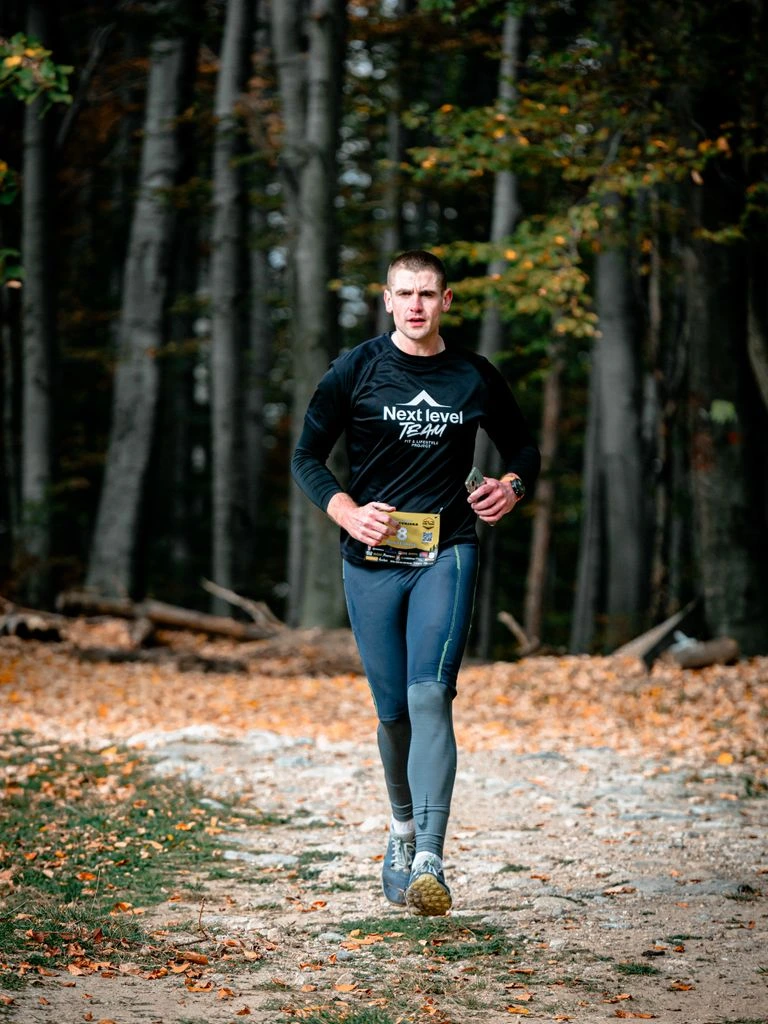 Runner mid-stride, focus locked on the running shoe.